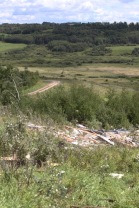 Debris from a house that was destroyed in Waywayseecappo First Nation is scattered throughout a valley. The house was pushed off its foundation at the top of a hill on Monday during a tornado-producing storm. (Eva Wasney/The Brandon Sun)